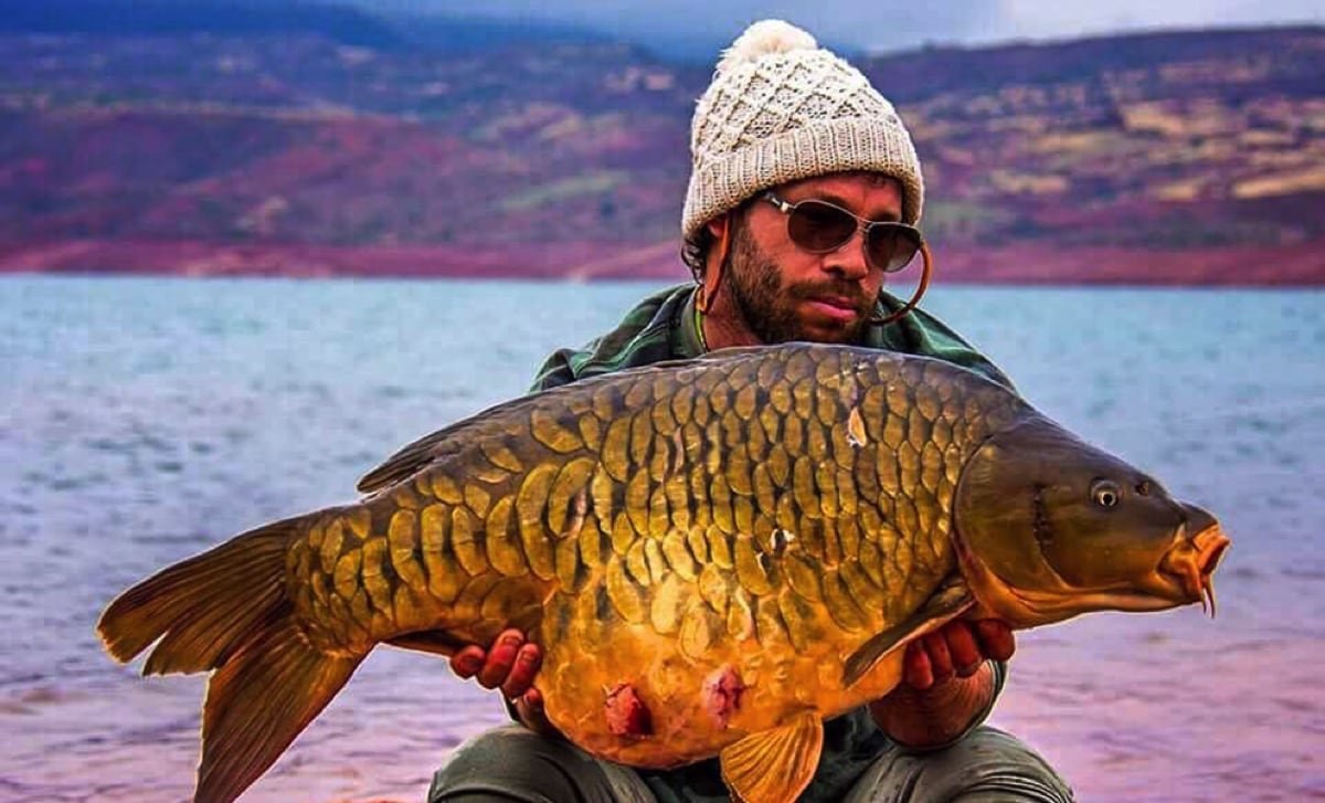 Sam holding big carp in Morocco