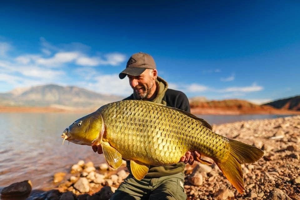 Angler holding carp caught on Lake Bin El Ouidane in Morocco