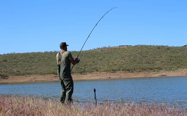 Sam Jefferys setting up 6 rods beside lake