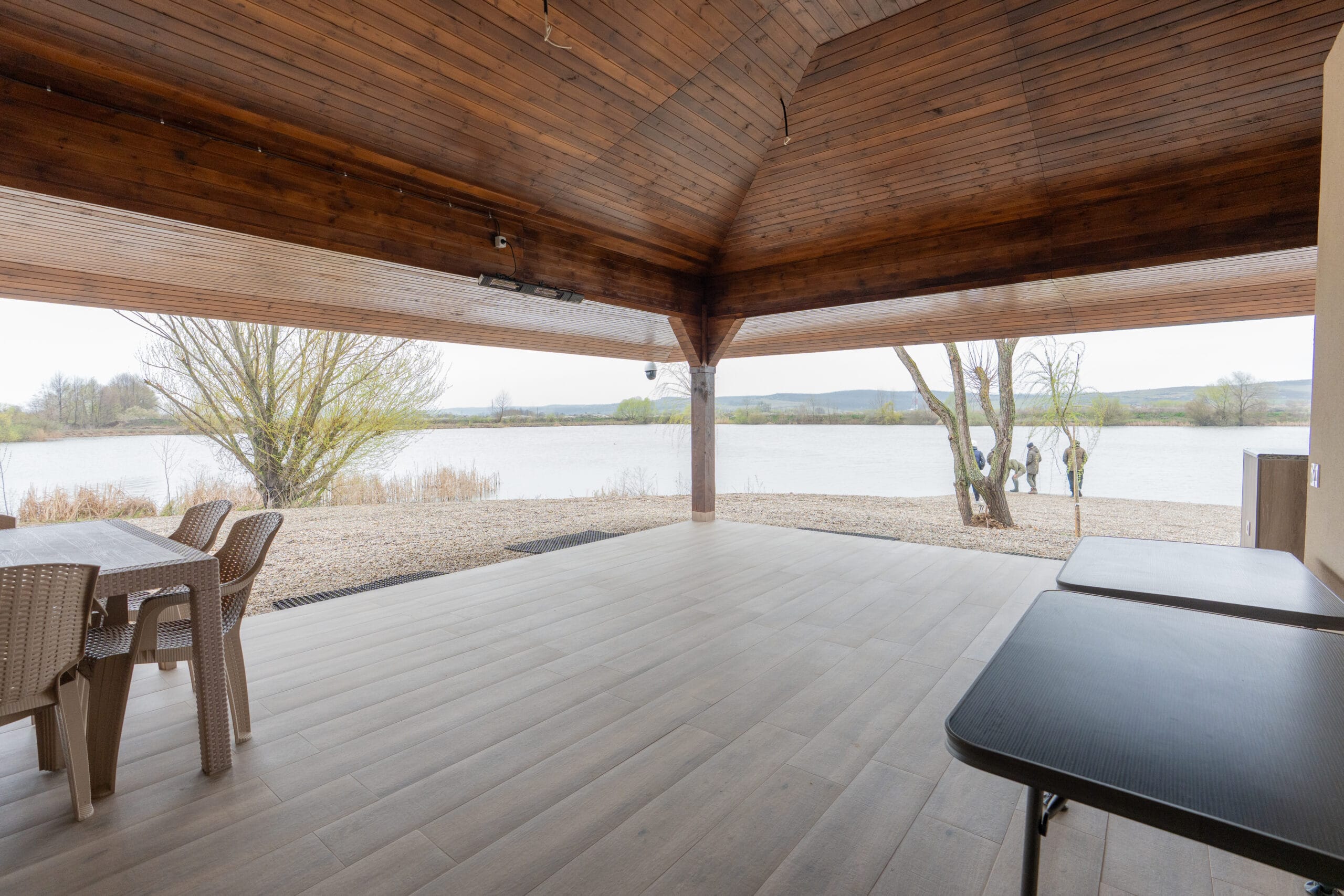 Covered terrace overlooking a scenic lake view.