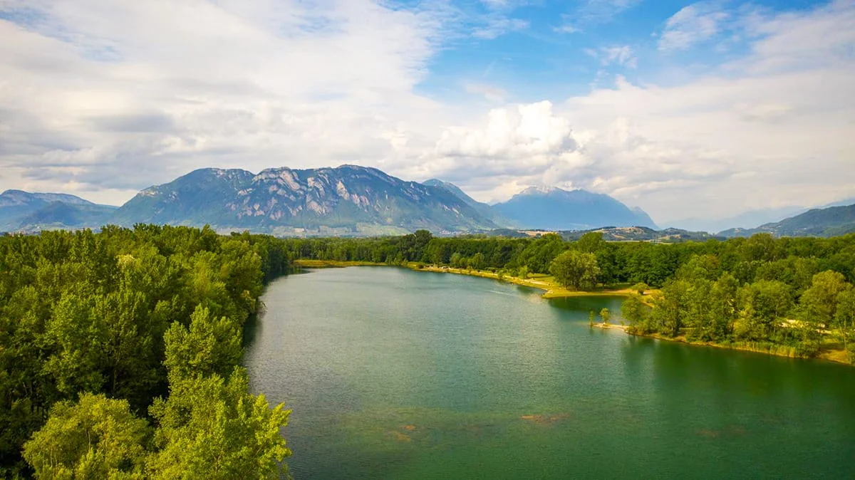 Scenic river view with mountains and trees.