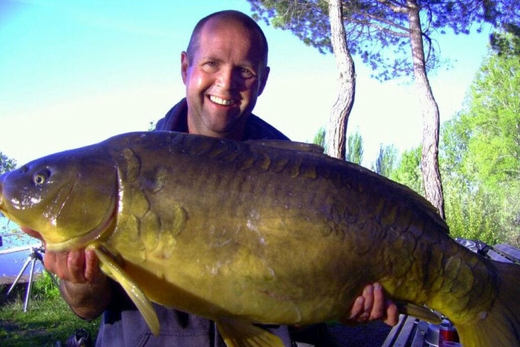 Man holding large fish outdoors
