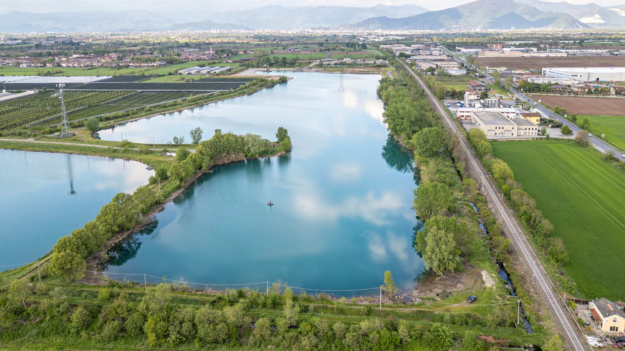Aerial view of serene lake and lush surroundings.