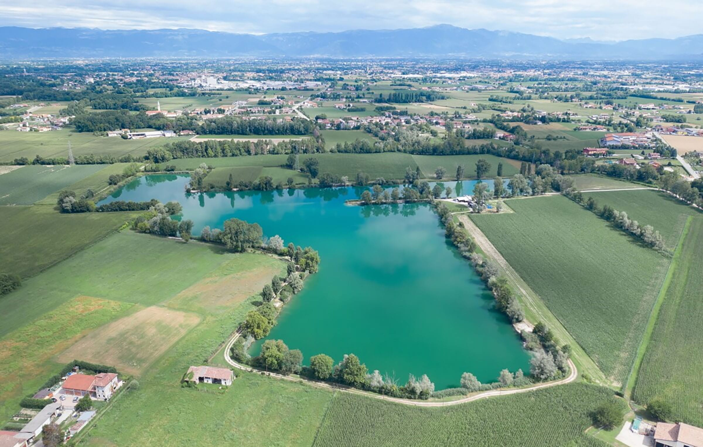 Aerial view of lake and farmland landscape.