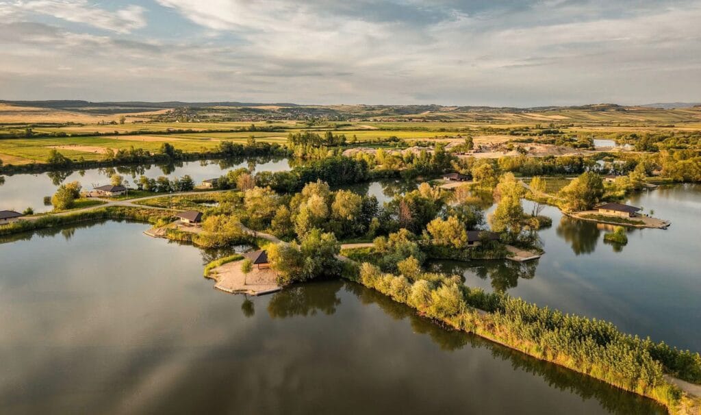 Scenic view of tranquil lakes and green landscape.